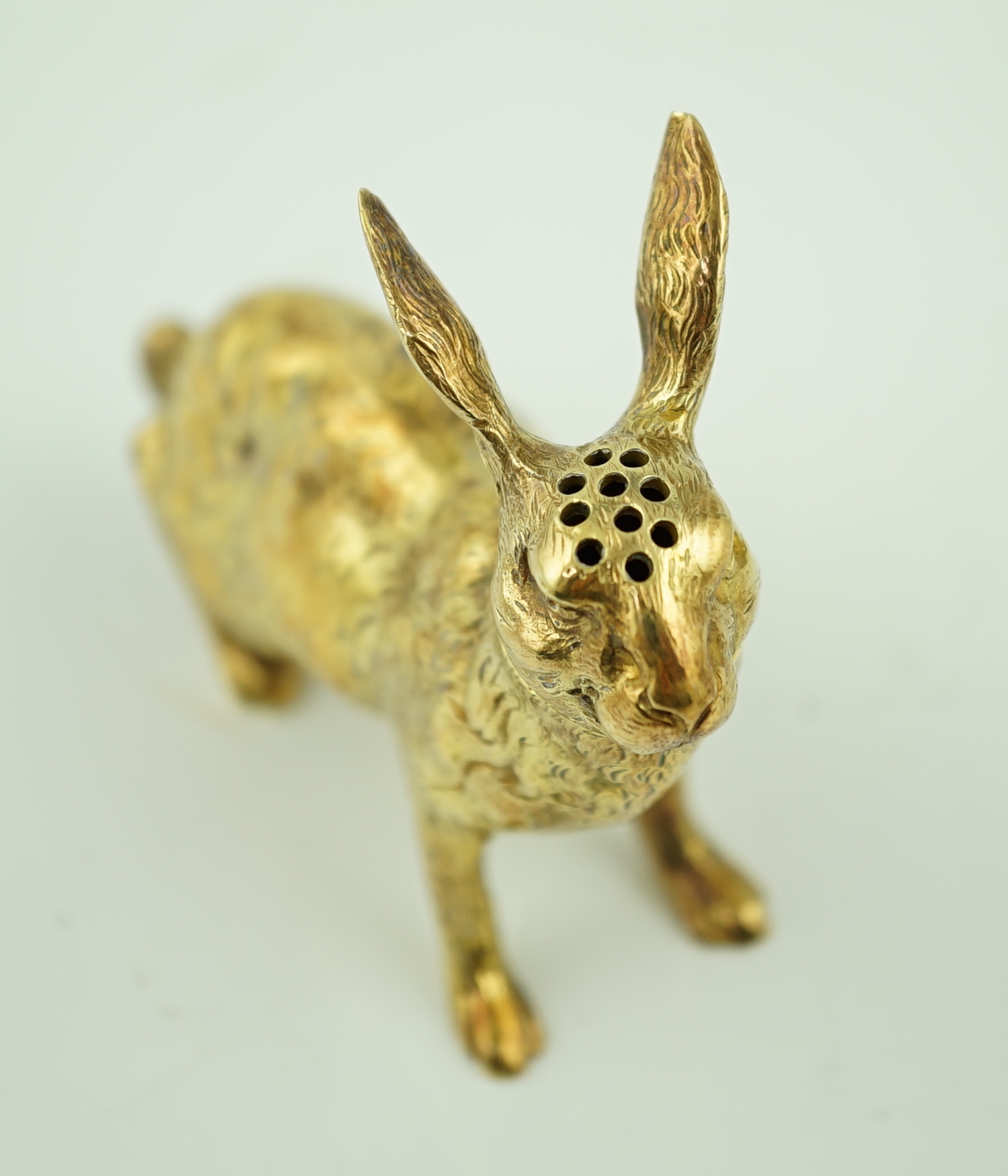 An early 20th century German novelty 800 standard silver gilt pepperette, modelled as a rabbit